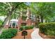 A brick condominium building with mature trees and well-manicured landscaping at 3636 Habersham Nw Rd # 2101, Atlanta, GA 30305
