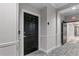 Hallway featuring a black door, neutral walls, and patterned carpeting at 3636 Habersham Nw Rd # 2101, Atlanta, GA 30305
