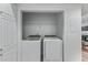Convenient laundry closet features a full-sized washer and dryer and built-in shelving at 3636 Habersham Nw Rd # 2101, Atlanta, GA 30305