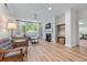 Bright living room featuring hardwood floors, a fireplace, and large windows at 3636 Habersham Nw Rd # 2101, Atlanta, GA 30305
