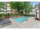 Community pool surrounded by lounge chairs and lush landscaping at 3636 Habersham Nw Rd # 2101, Atlanta, GA 30305