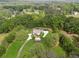 Expansive aerial view showcases a private estate surrounded by lush greenery and mature trees at 4740 Union Hill Rd, Canton, GA 30115