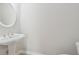 This half bathroom features a pedestal sink and oval mirror at 4740 Union Hill Rd, Canton, GA 30115