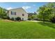 Side view of home exterior with big green lawn, mature trees, and convenient driveway at 4740 Union Hill Rd, Canton, GA 30115