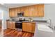Well-lit kitchen with stainless steel appliances, light wood cabinetry, and solid surface countertops at 4740 Union Hill Rd, Canton, GA 30115