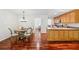 Bright kitchen featuring hardwood floors, breakfast bar, light wood cabinetry, and open dining area at 4740 Union Hill Rd, Canton, GA 30115