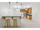 Eat-in kitchen with breakfast bar, white appliances, tile floors and natural wood cabinets at 4740 Union Hill Rd, Canton, GA 30115