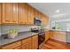 Modern kitchen with stainless steel appliances, light wood cabinets and a view to the outdoors at 4740 Union Hill Rd, Canton, GA 30115