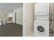 Convenient laundry area with stacked washer and dryer unit, saving space and adding functionality at 4740 Union Hill Rd, Canton, GA 30115