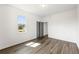 Bright bedroom with wood floors, a large window and gray closet doors providing natural light at 585 Ira Sw St, Atlanta, GA 30312