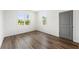 Bedroom with wood floors, two large windows providing natural light and a gray door at 585 Ira Sw St, Atlanta, GA 30312