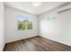 Bedroom with a large window providing natural light, wood-look flooring, and mini split AC at 585 Ira Sw St, Atlanta, GA 30312