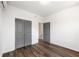 Bedroom featuring wood floors, closet with gray doors, and natural light from an open doorway at 585 Ira Sw St, Atlanta, GA 30312