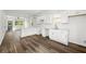 Open-concept kitchen features bright white cabinets, hardwood floors and modern countertops at 585 Ira Sw St, Atlanta, GA 30312