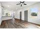 Open-concept living room with wood floors, ceiling fan, and natural light from large windows at 585 Ira Sw St, Atlanta, GA 30312