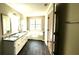 Bathroom with dual sinks, granite countertops, and a soaking tub at 60 Whispering Pine Ct, Covington, GA 30016