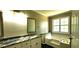 Bathroom features a soaking tub and vanity with granite countertop at 60 Whispering Pine Ct, Covington, GA 30016