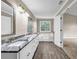Bright bathroom with double vanities, granite countertops, and separate tub at 60 Whispering Pine Ct, Covington, GA 30016