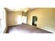 Spacious bedroom with tall ceilings, ceiling fan, carpet floors, and bathroom access at 60 Whispering Pine Ct, Covington, GA 30016