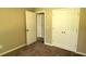Bedroom features a bi-fold closet and view of open door into hall at 60 Whispering Pine Ct, Covington, GA 30016