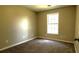 Bedroom featuring a window and neutral colored walls and carpeting at 60 Whispering Pine Ct, Covington, GA 30016