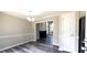 Open dining room with gray flooring and a view into the living room and its fireplace at 60 Whispering Pine Ct, Covington, GA 30016