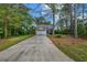 Well maintained traditional-style home with a long driveway and lush, green lawn at 60 Whispering Pine Ct, Covington, GA 30016