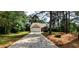 Inviting front exterior with attached garage and long driveway bordered by mature trees at 60 Whispering Pine Ct, Covington, GA 30016