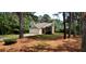 Charming home with a manicured lawn, a stone-accented entrance, and an attached garage at 60 Whispering Pine Ct, Covington, GA 30016