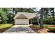 Charming single-Gathering home with stone accents, a two-car garage and a well-maintained lawn at 60 Whispering Pine Ct, Covington, GA 30016