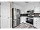 Updated kitchen featuring stainless steel appliances, granite countertops, and stylish backsplash at 60 Whispering Pine Ct, Covington, GA 30016