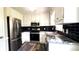 Modern kitchen with stainless steel appliances, sleek granite countertops, and updated cabinetry at 60 Whispering Pine Ct, Covington, GA 30016