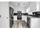Updated kitchen featuring stainless steel appliances, granite countertops, and stylish backsplash at 60 Whispering Pine Ct, Covington, GA 30016