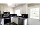 Modern kitchen with stainless steel appliances, sleek granite countertops, and updated cabinetry at 60 Whispering Pine Ct, Covington, GA 30016
