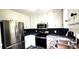 Modern kitchen with stainless steel appliances, sleek granite countertops, and updated cabinetry at 60 Whispering Pine Ct, Covington, GA 30016