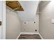 A utility room with hardwood-look flooring, drywall, and connections for laundry machines at 60 Whispering Pine Ct, Covington, GA 30016