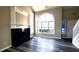 Bright living room with tall ceilings, laminate flooring, fireplace, and large arched window at 60 Whispering Pine Ct, Covington, GA 30016