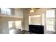 Open living room with tall ceilings, laminate flooring, fireplace, and great natural light at 60 Whispering Pine Ct, Covington, GA 30016