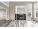 Bright living room featuring fireplace, lots of natural light and beautiful laminate flooring at 60 Whispering Pine Ct, Covington, GA 30016