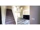 Bright, airy living room features high ceilings, modern flooring, and fireplace, with stairs to the second floor at 60 Whispering Pine Ct, Covington, GA 30016