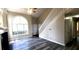 Bright, airy living room features high ceilings, modern flooring, and fireplace, with stairs to the second floor at 60 Whispering Pine Ct, Covington, GA 30016