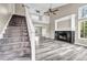 Bright living room featuring fireplace, lots of natural light and beautiful laminate flooring at 60 Whispering Pine Ct, Covington, GA 30016
