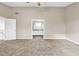 Spacious carpeted main bedroom with ensuite bathroom and modern ceiling fan at 60 Whispering Pine Ct, Covington, GA 30016
