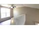 Bright upstairs landing area with carpet, white railing, and a sunlit window at 60 Whispering Pine Ct, Covington, GA 30016