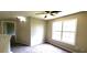 Bright upstairs bedroom with carpet, neutral walls, ceiling fan, and a window at 60 Whispering Pine Ct, Covington, GA 30016