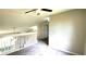 Open upstairs area with carpet, white railing, and a view of a bedroom at 60 Whispering Pine Ct, Covington, GA 30016