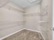 Spacious walk-in closet with ample shelving and carpeted floor at 60 Whispering Pine Ct, Covington, GA 30016