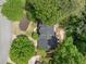Aerial perspective of roof of home surrounded by lush trees, showcases landscaping and nearby houses at 815 Lake Forest Pass, Roswell, GA 30076