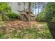 Multi-tiered backyard with terraced landscaping, fence, and home's multilevel deck at 815 Lake Forest Pass, Roswell, GA 30076
