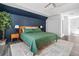 A bedroom featuring a green bedspread with a tree beside the bed at 815 Lake Forest Pass, Roswell, GA 30076